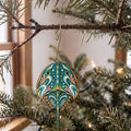 Laser-cut maple wood Horseshoe Crab folk art ornament O183 hanging on a fir branch, made in USA
