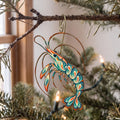 Laser-cut maple wood Cleaner Shrimp folk art ornament O185 hanging on a fir branch, made in USA