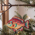 Laser-cut maple wood Pumpkinseed Sunfish folk art ornament O190 hanging on a fir branch, made in USA