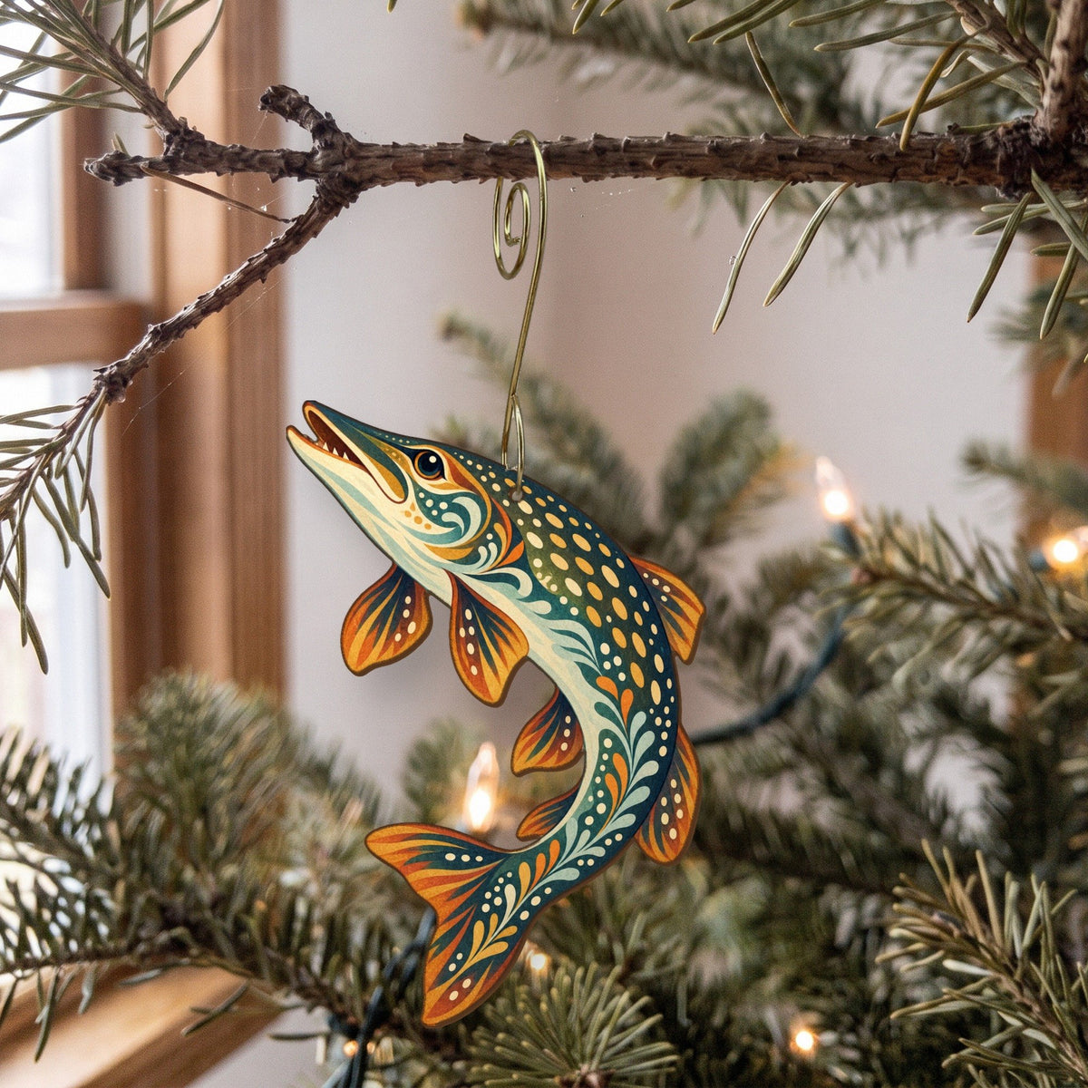 Laser-cut maple wood Northern Pike folk art ornament O194 hanging on a fir branch, made in USA