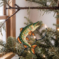 Laser-cut maple wood Muskellunge folk art ornament O195 hanging on a fir branch, made in USA