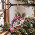 Laser-cut maple wood Freshwater Drum folk art ornament O204 hanging on a fir branch, made in USA