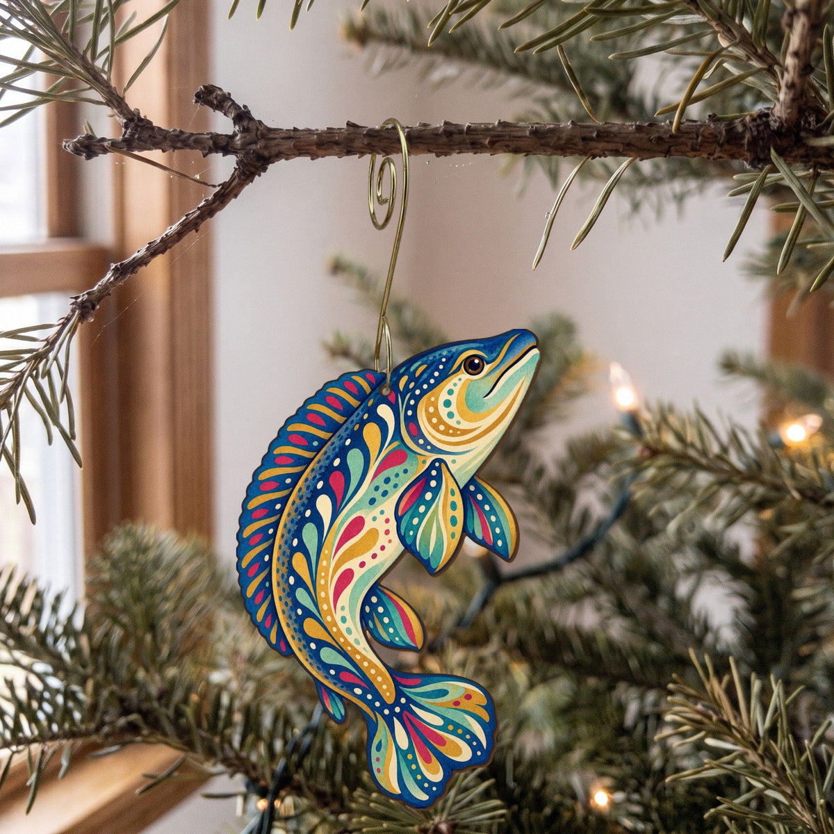 Laser-cut maple wood Bowfin folk art ornament O205 hanging on a fir branch, made in USA