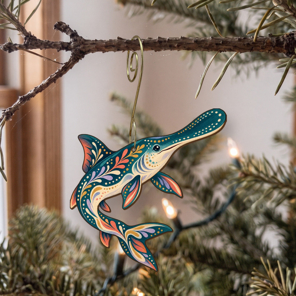 Laser-cut maple wood American Paddlefish folk art ornament O207 hanging on a fir branch, made in USA