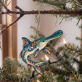 Laser-cut maple wood American Paddlefish folk art ornament O207 hanging on a fir branch, made in USA