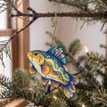 Laser-cut maple wood Tench folk art ornament O213 hanging on a fir branch, made in USA