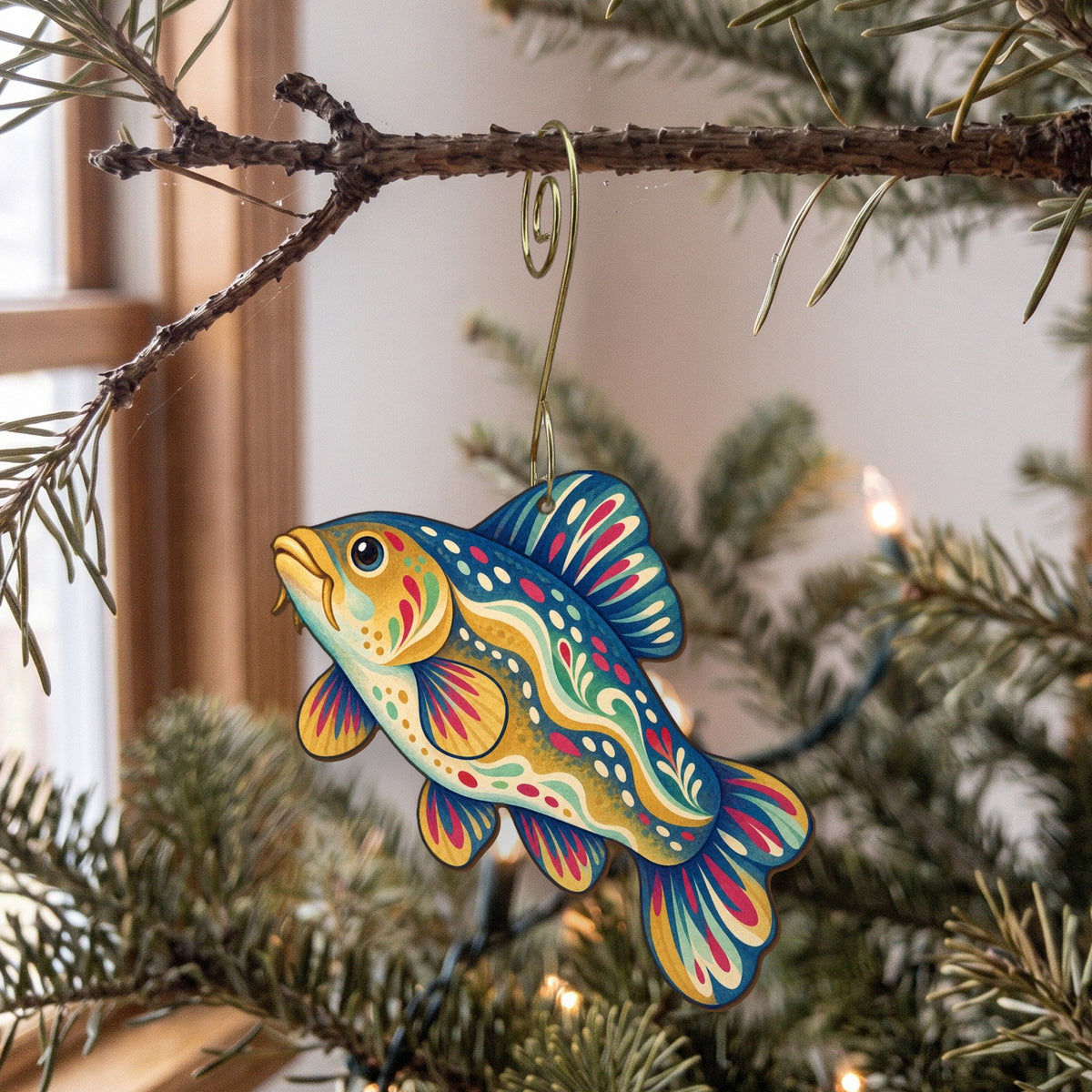 Laser-cut maple wood Tench folk art ornament O213 hanging on a fir branch, made in USA