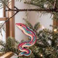 Laser-cut maple wood Freshwater Eel folk art ornament O216 hanging on a fir branch, made in USA