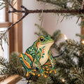 Laser-cut maple wood Green Frog folk art ornament O219 hanging on a fir branch, made in USA
