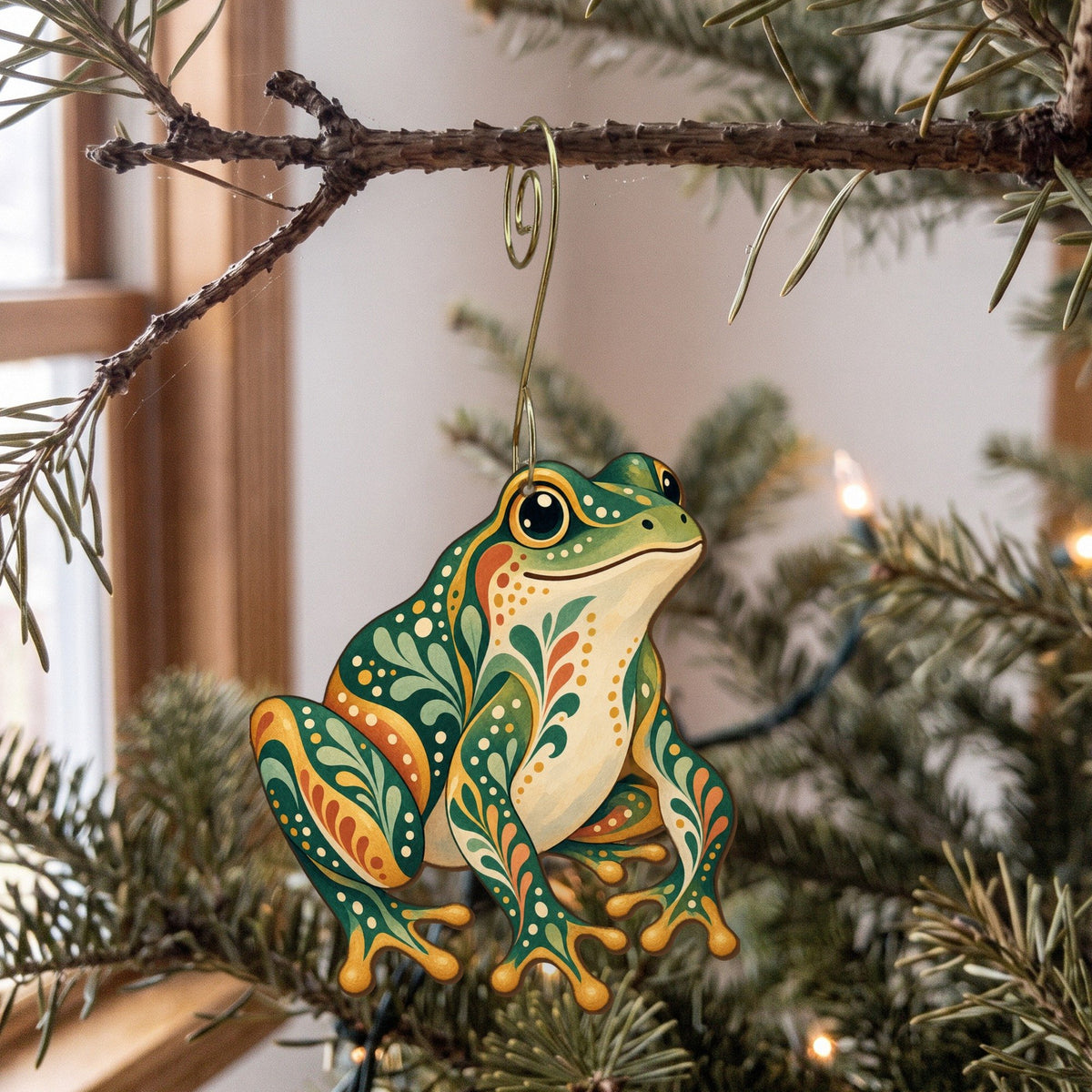 Laser-cut maple wood Green Frog folk art ornament O219 hanging on a fir branch, made in USA