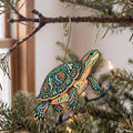 Laser-cut maple wood Painted Turtle folk art ornament O223 hanging on a fir branch, made in USA