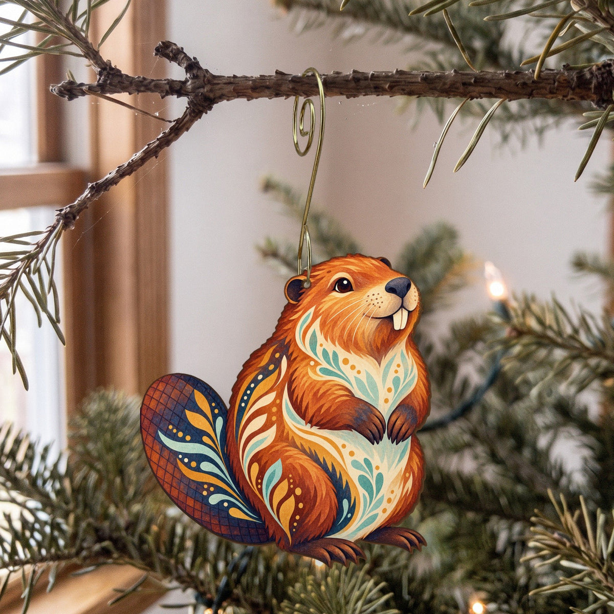 Laser-cut maple wood American Beaver folk art ornament O226 hanging on a fir branch, made in USA