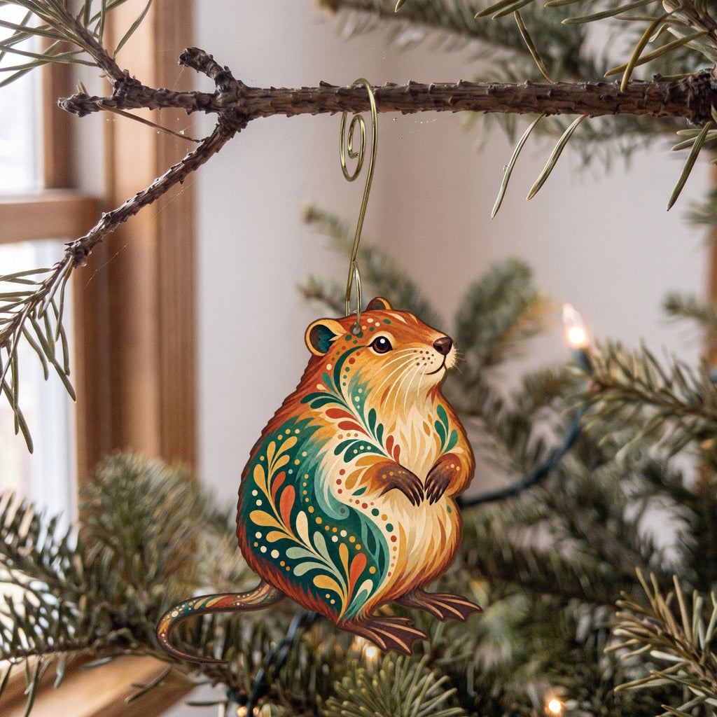 Laser-cut maple wood Muskrat folk art ornament O227 hanging on a fir branch, made in USA