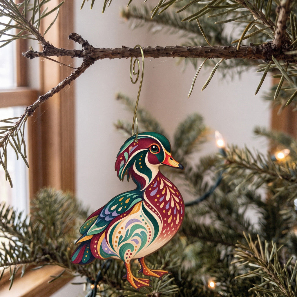 Laser-cut maple wood Wood Duck folk art ornament O230 hanging on a fir branch, made in USA