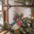 Laser-cut maple wood Wood Duck folk art ornament O230 hanging on a fir branch, made in USA
