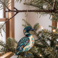 Laser-cut maple wood Common Loon folk art ornament O231 hanging on a fir branch, made in USA