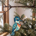 Laser-cut maple wood Belted Kingfisher folk art ornament O233 hanging on a fir branch, made in USA