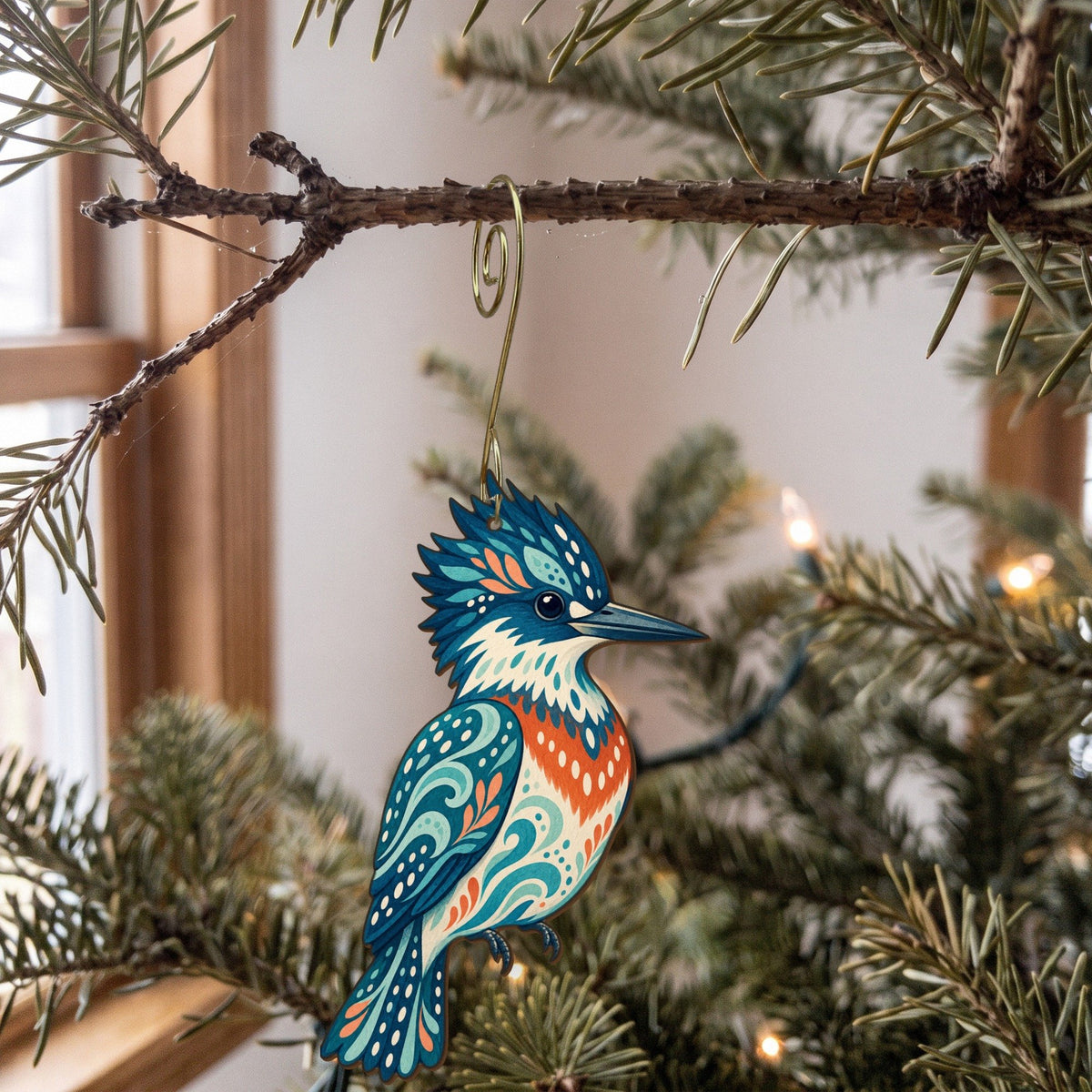 Laser-cut maple wood Belted Kingfisher folk art ornament O233 hanging on a fir branch, made in USA