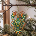 Laser-cut maple wood Crayfish folk art ornament O235 hanging on a fir branch, made in USA