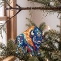 Laser-cut maple wood American Bison folk art ornament O237 hanging on a fir branch, made in USA