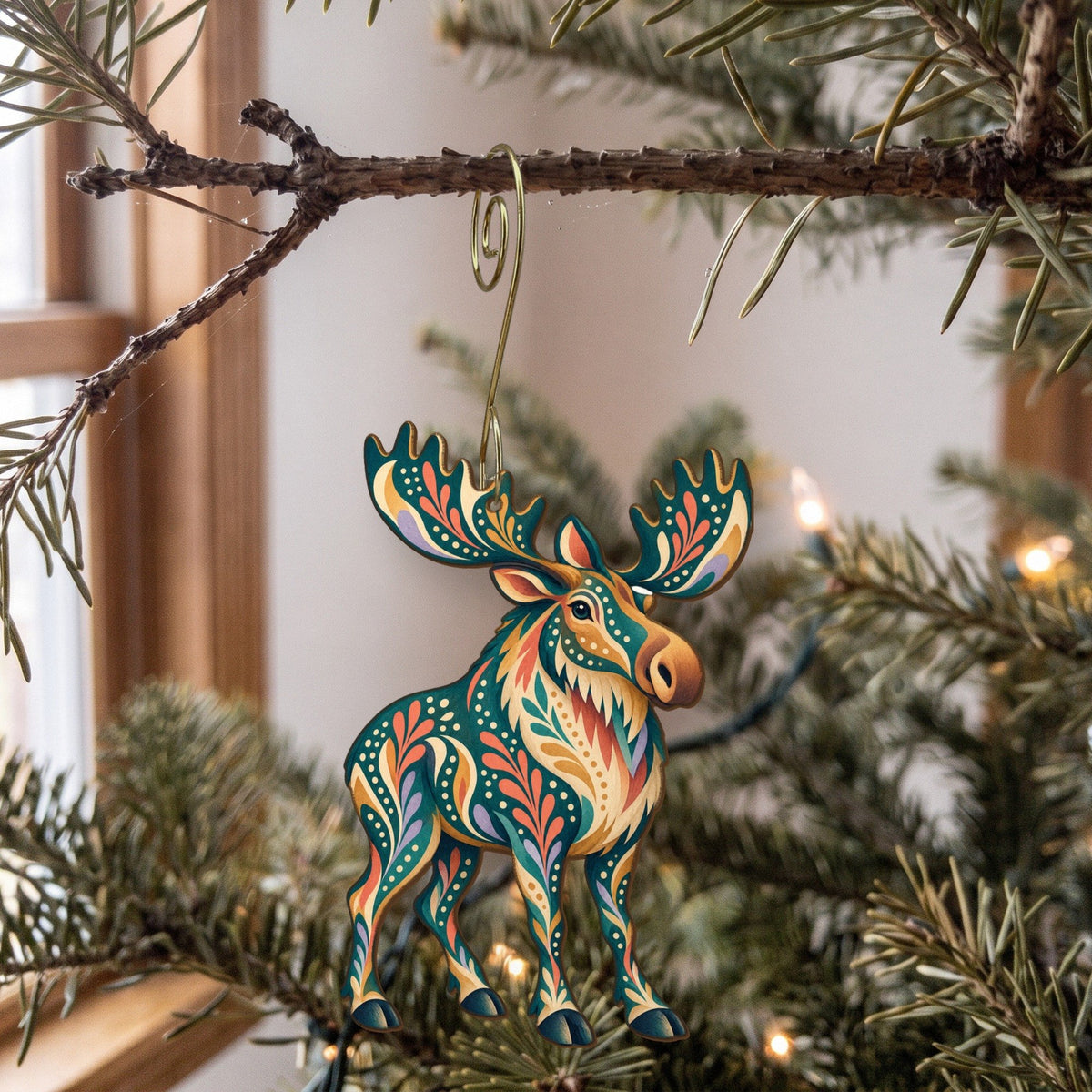 Laser-cut maple wood Moose folk art ornament O239 hanging on a fir branch, made in USA