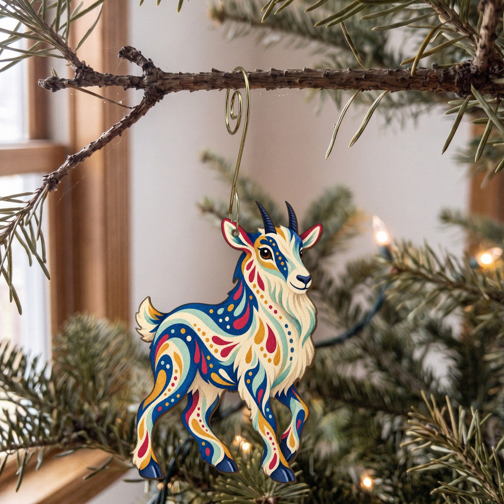 Laser-cut maple wood Mountain Goat folk art ornament O245 hanging on a fir branch, made in USA