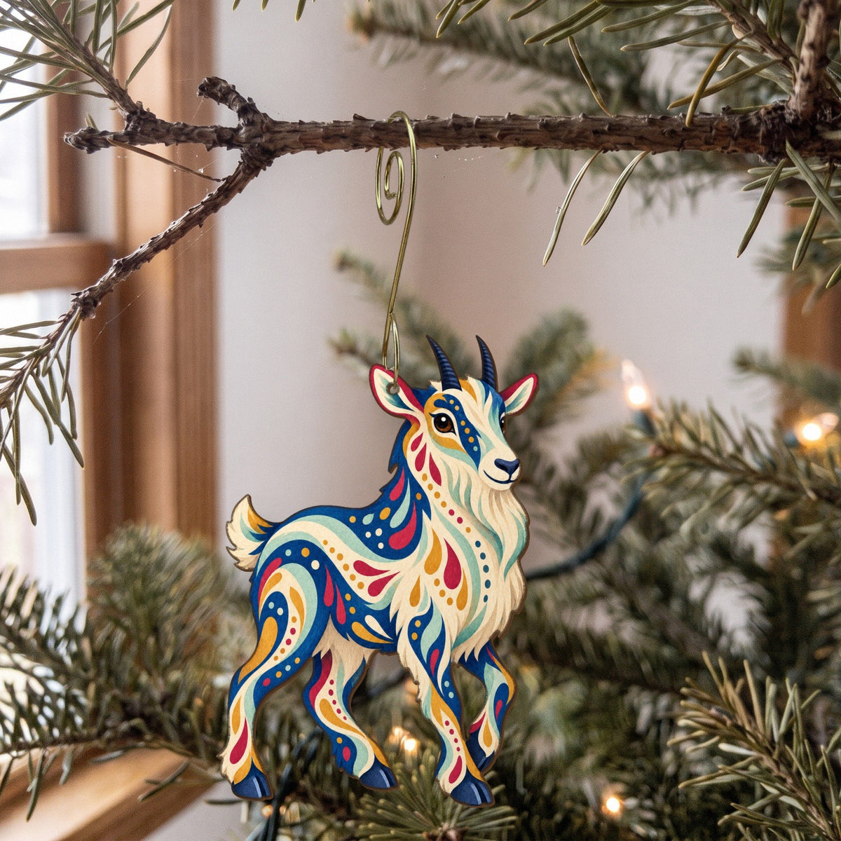 Laser-cut maple wood Mountain Goat folk art ornament O245 hanging on a fir branch, made in USA