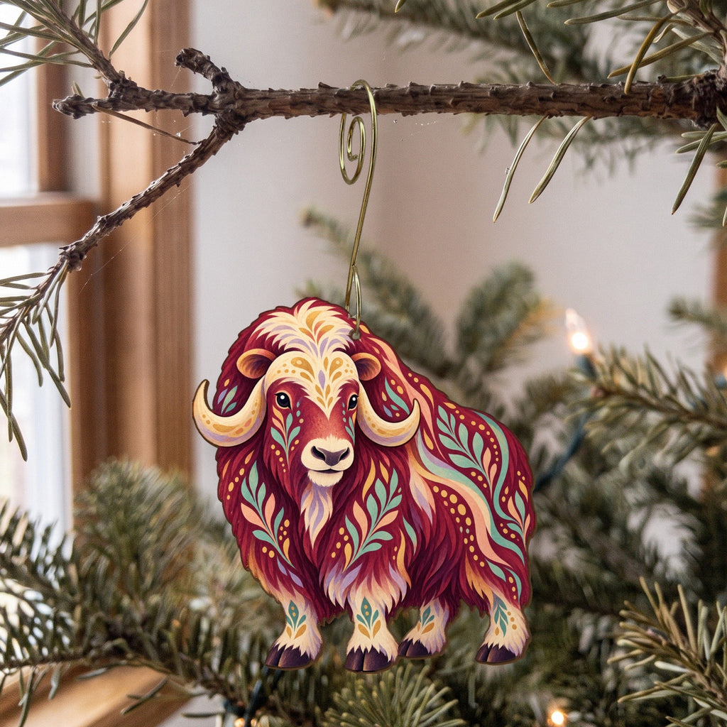 Laser-cut maple wood Musk Ox folk art ornament O246 hanging on a fir branch, made in USA