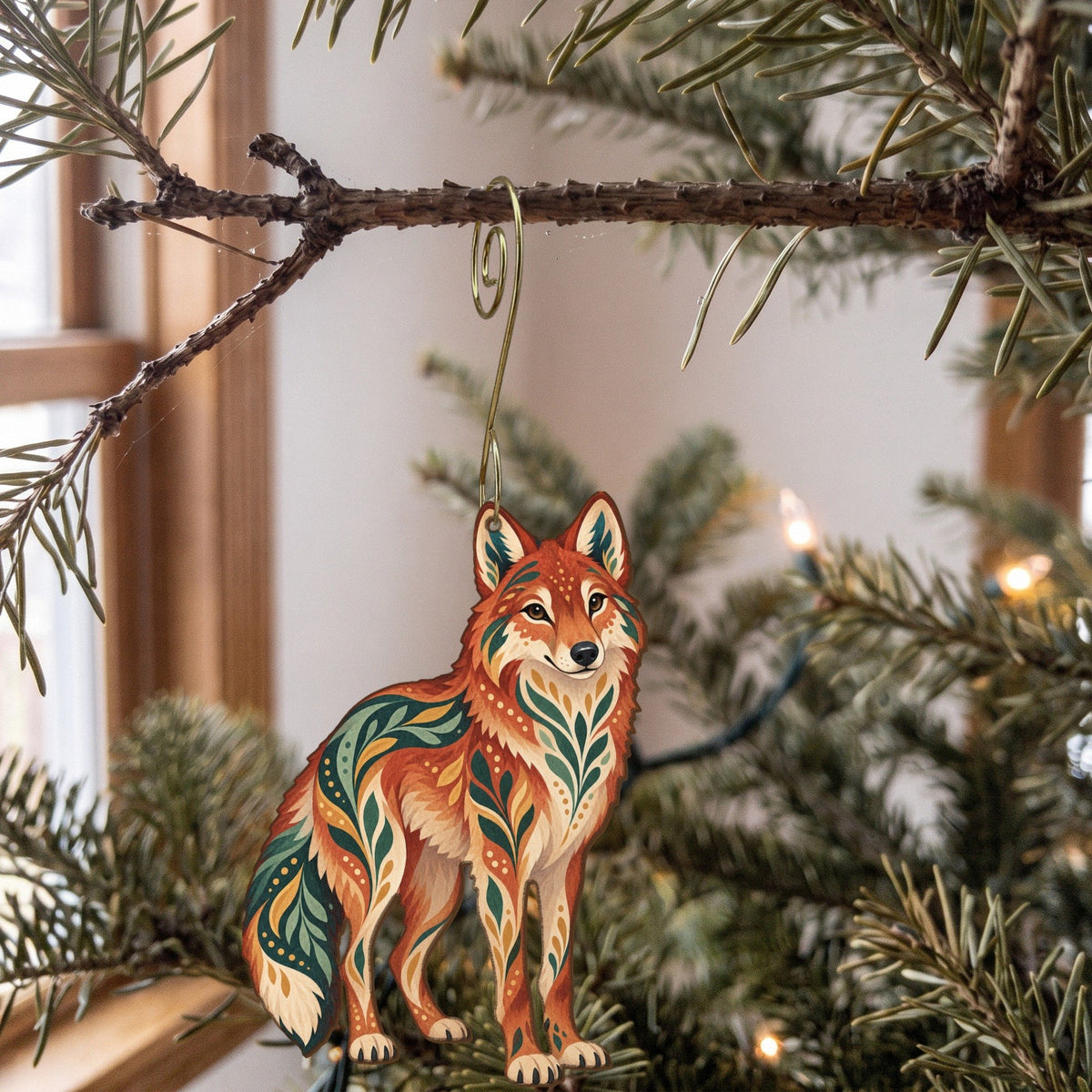 Laser-cut maple wood Red Wolf folk art ornament O251 hanging on a fir branch, made in USA