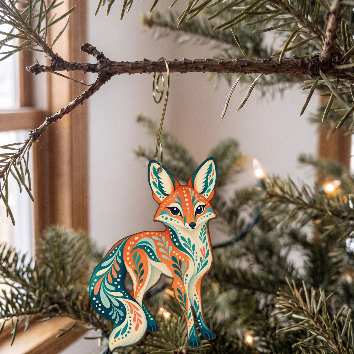 Laser-cut maple wood Kit Fox folk art ornament O257 hanging on a fir branch, made in USA