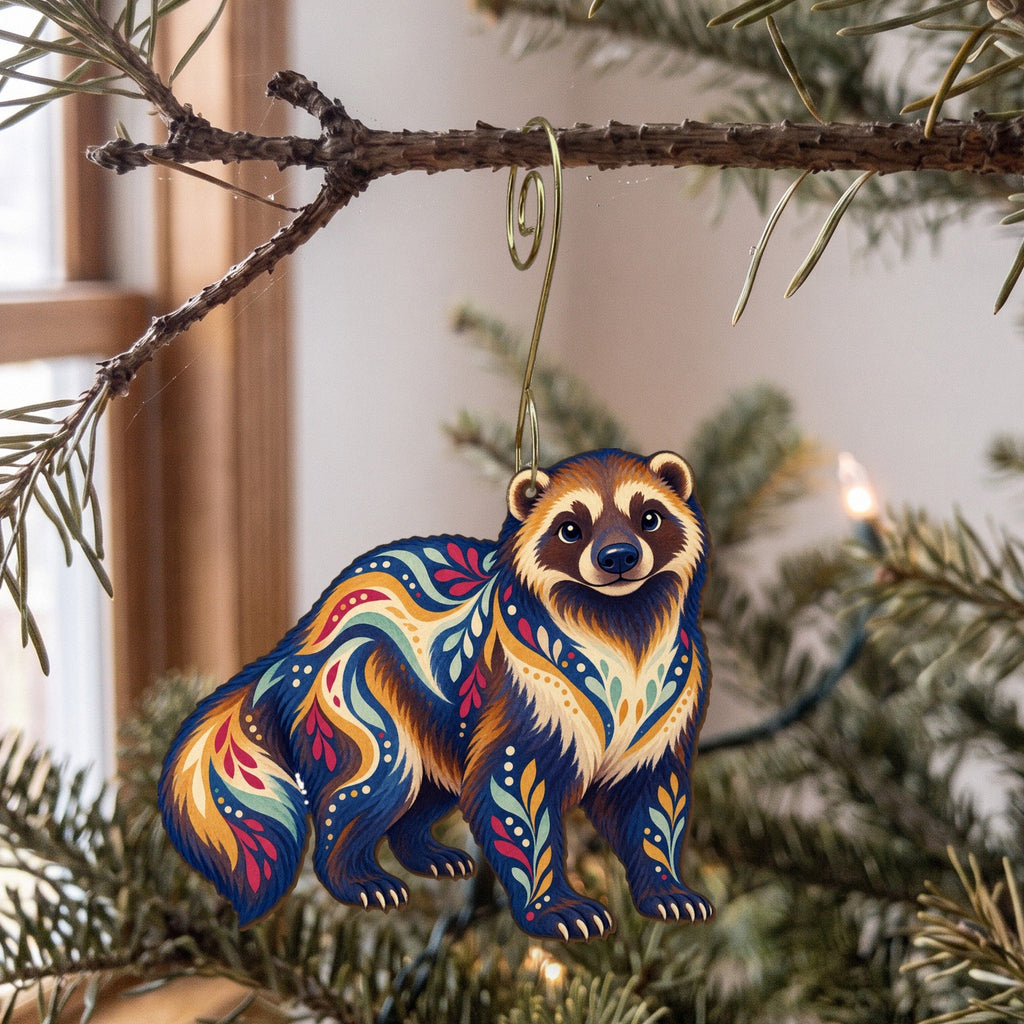 Laser-cut maple wood Wolverine folk art ornament O261 hanging on a fir branch, made in USA