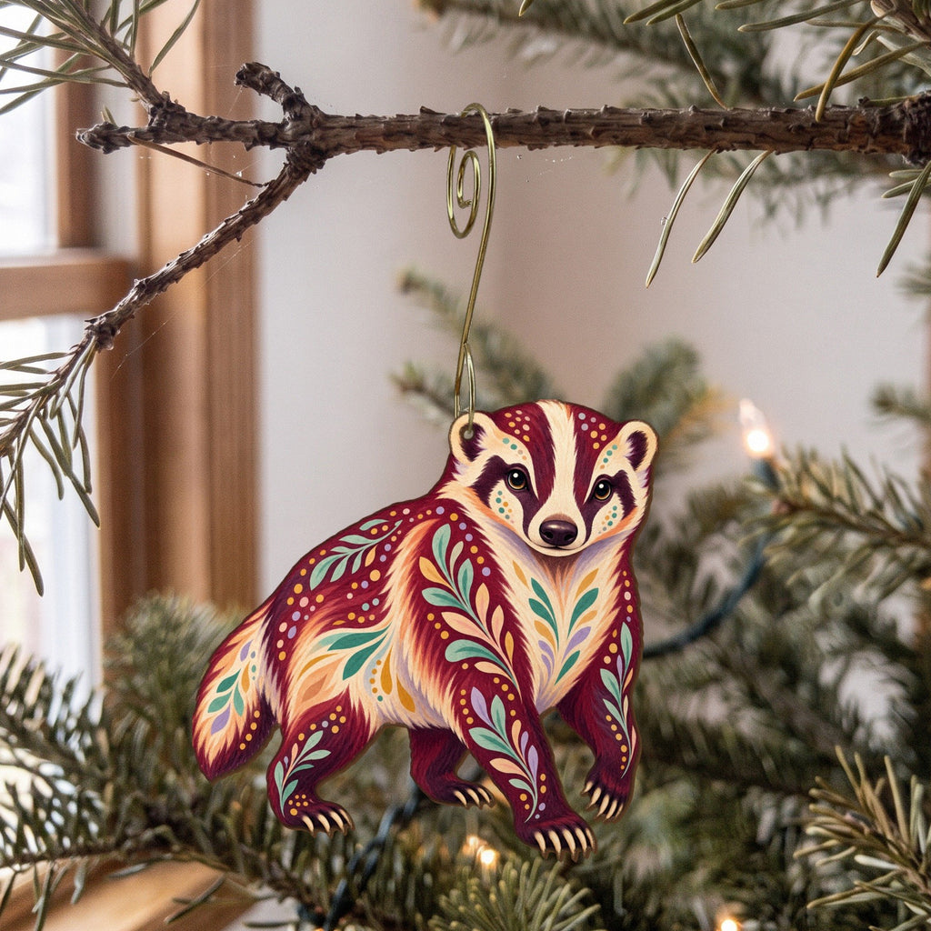 Laser-cut maple wood American Badger folk art ornament O262 hanging on a fir branch, made in USA