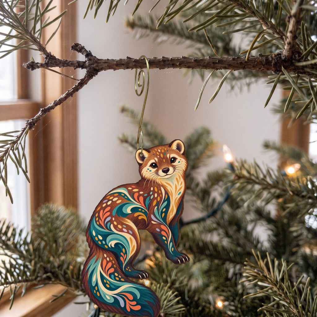 Laser-cut maple wood Fisher folk art ornament O263 hanging on a fir branch, made in USA