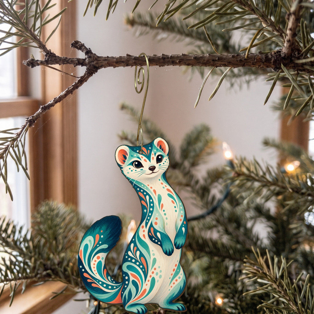 Laser-cut maple wood Ermine folk art ornament O265 hanging on a fir branch, made in USA