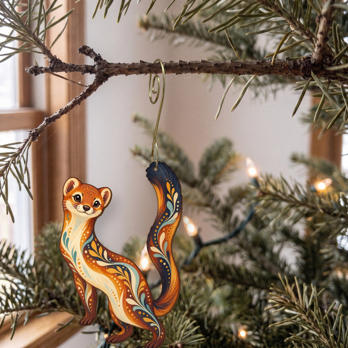 Laser-cut maple wood Long-Tailed Weasel folk art ornament O266 hanging on a fir branch, made in USA