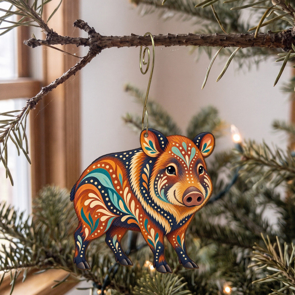 Laser-cut maple wood Javelina folk art ornament O274 hanging on a fir branch, made in USA