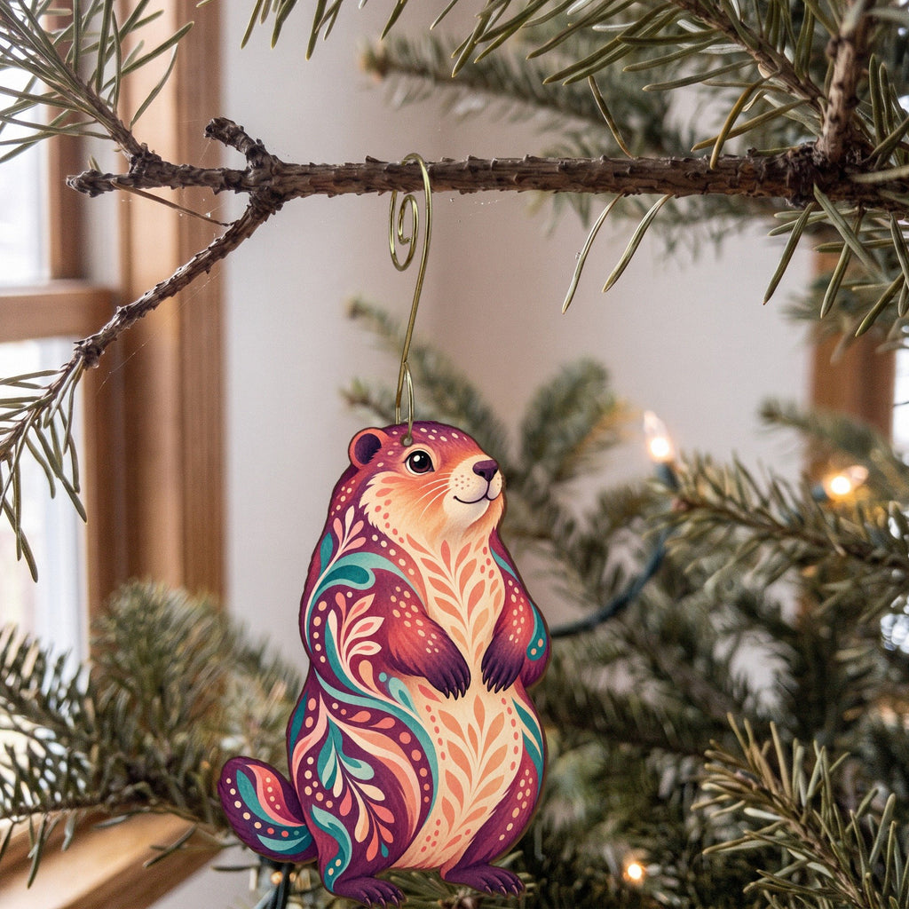 Laser-cut maple wood Woodchuck folk art ornament O276 hanging on a fir branch, made in USA