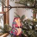 Laser-cut maple wood Woodchuck folk art ornament O276 hanging on a fir branch, made in USA