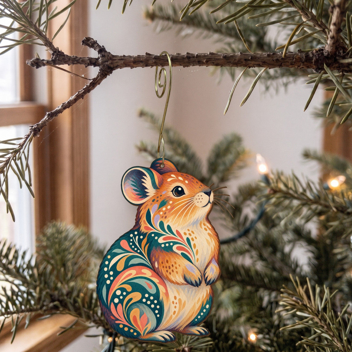 Laser-cut maple wood American Pika folk art ornament O279 hanging on a fir branch, made in USA