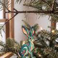 Laser-cut maple wood Black-Tailed Jackrabbit folk art ornament O281 hanging on a fir branch, made in USA