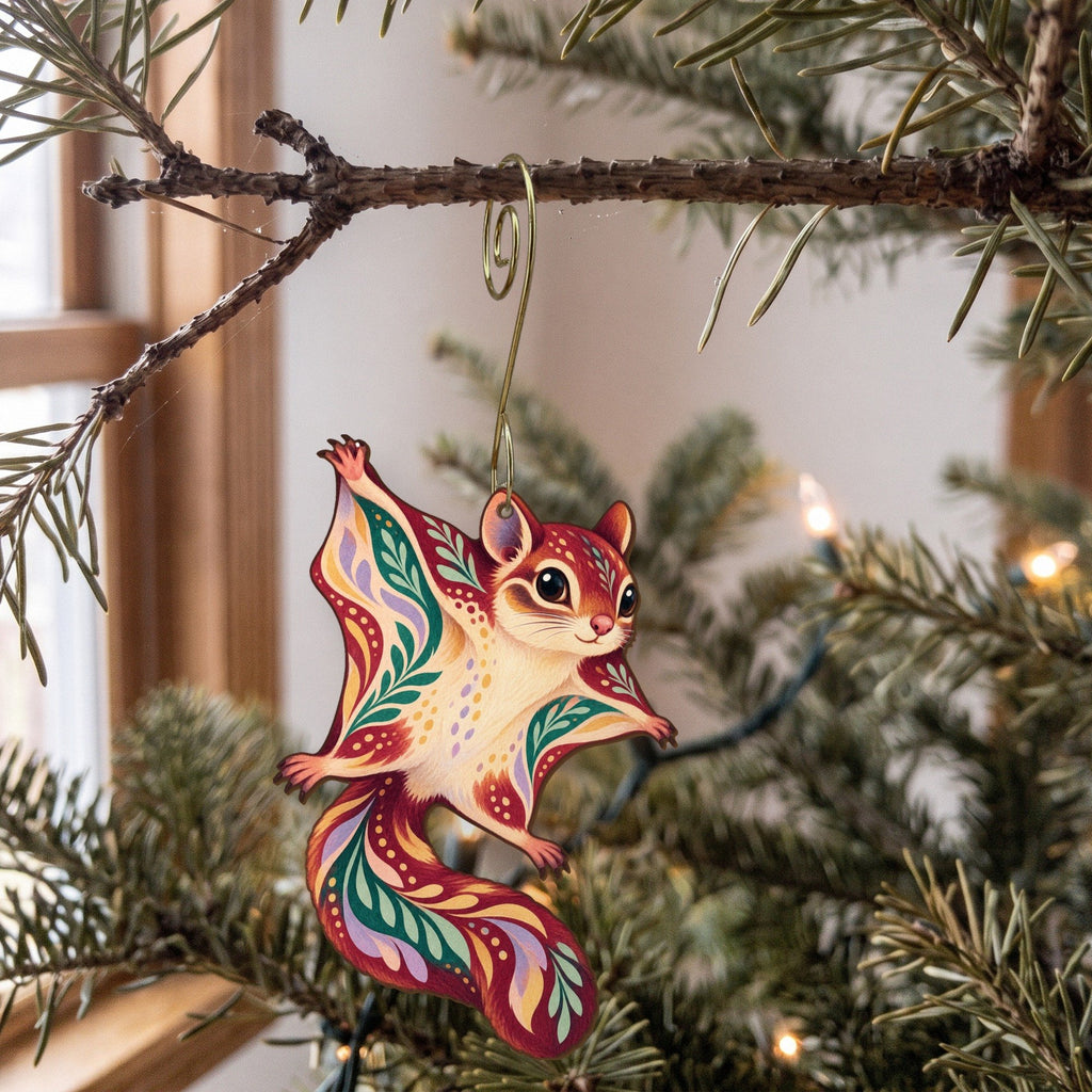 Laser-cut maple wood Northern Flying Squirrel folk art ornament O286 hanging on a fir branch, made in USA