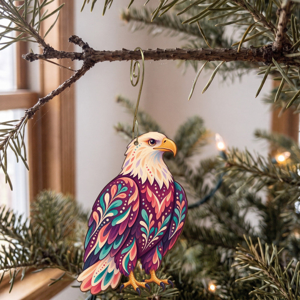Laser-cut maple wood Bald Eagle folk art ornament O292 hanging on a fir branch, made in USA