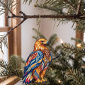 Laser-cut maple wood Golden Eagle folk art ornament O293 hanging on a fir branch, made in USA