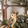 Laser-cut maple wood Barn Owl folk art ornament O298 hanging on a fir branch, made in USA