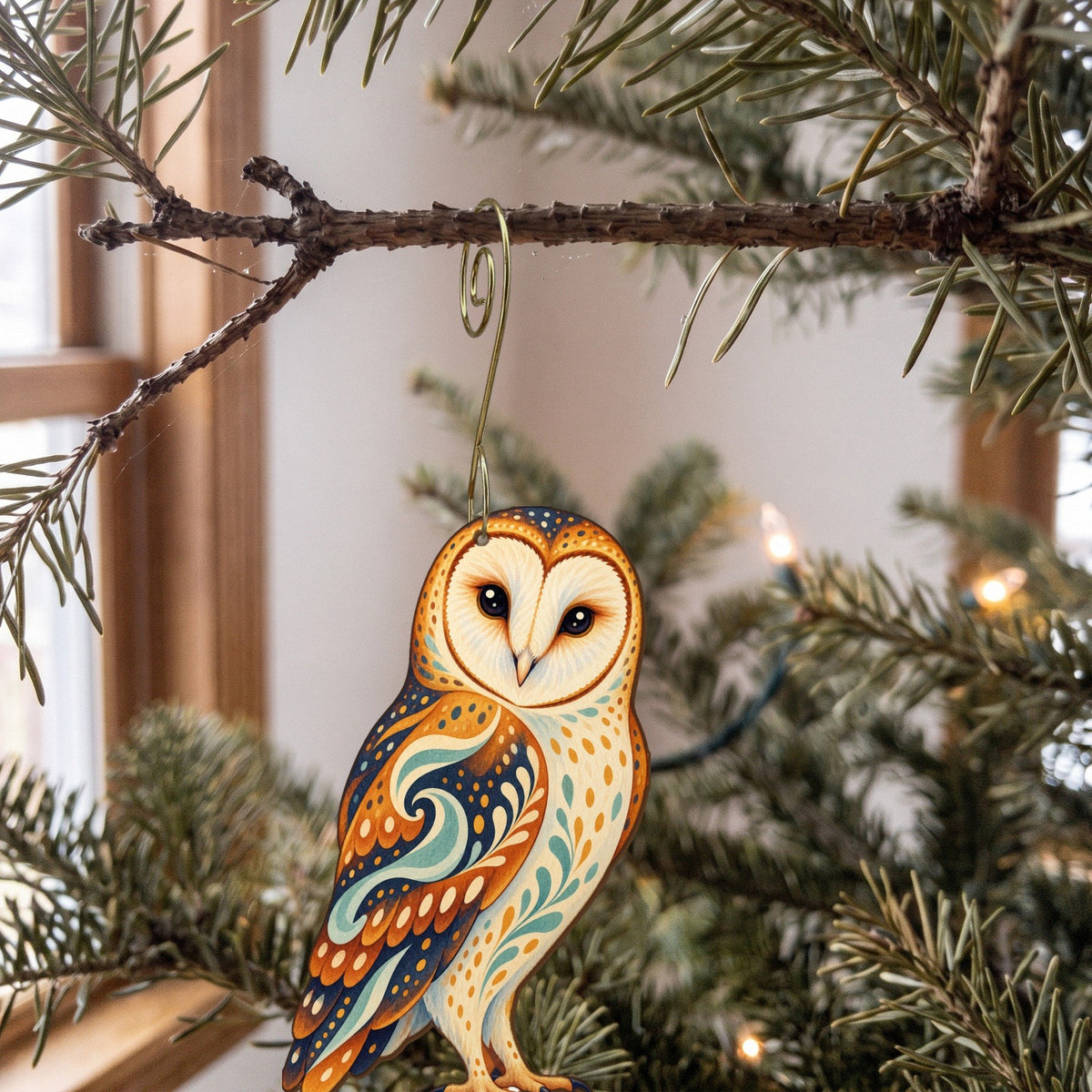 Laser-cut maple wood Barn Owl folk art ornament O298 hanging on a fir branch, made in USA
