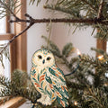 Laser-cut maple wood Snowy Owl folk art ornament O299 hanging on a fir branch, made in USA