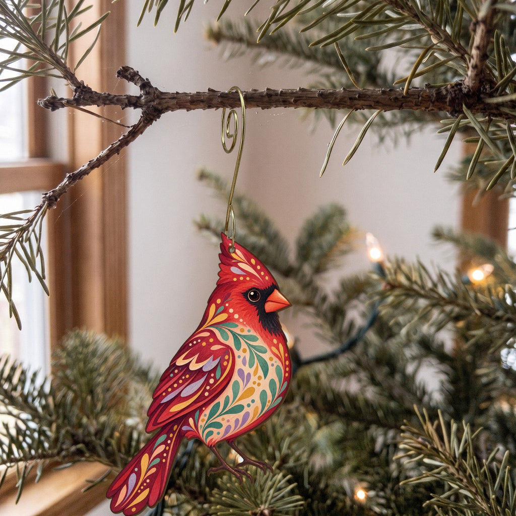 Laser-cut maple wood Northern Cardinal folk art ornament O302 hanging on a fir branch, made in USA