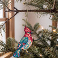 Laser-cut maple wood Steller's Jay folk art ornament O304 hanging on a fir branch, made in USA