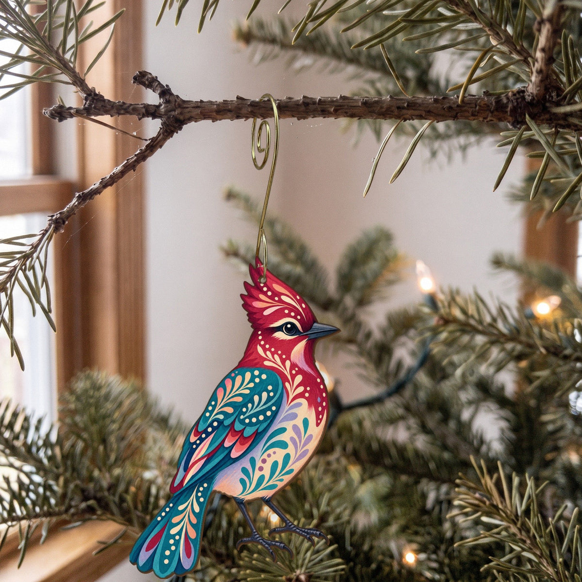 Laser-cut maple wood Steller's Jay folk art ornament O304 hanging on a fir branch, made in USA