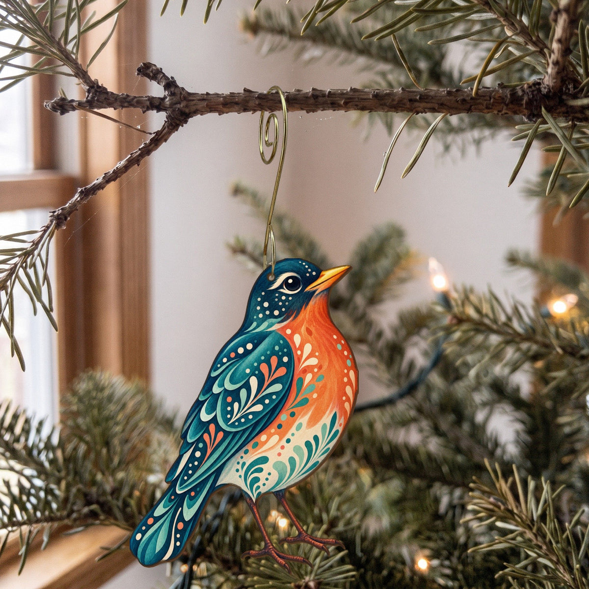 Laser-cut maple wood American Robin folk art ornament O305 hanging on a fir branch, made in USA